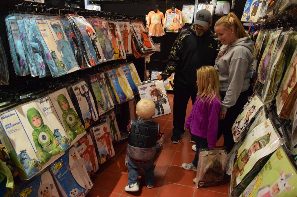 The Carr family, including Anavaya, 6, who picked out an M3GAN costume, and Colton, 2, who picked out Mater from Cars, shopping at the Spirit Halloween store.